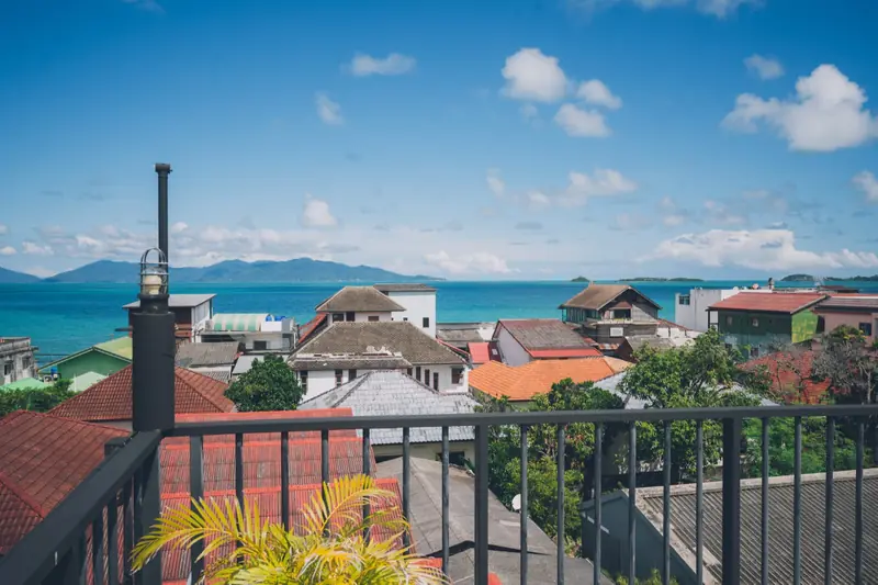 Fisherman’s Village rooftops, turquoise sea and mountains beyond